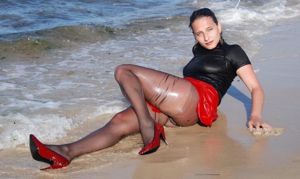 Brunette Young Girl wearing Wet Black Sheer Pantyhose and Red Skirt